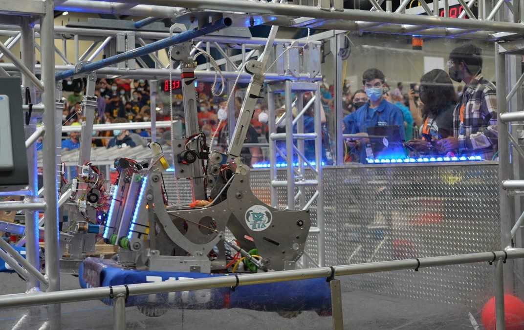 FRC robot climbing up bars.