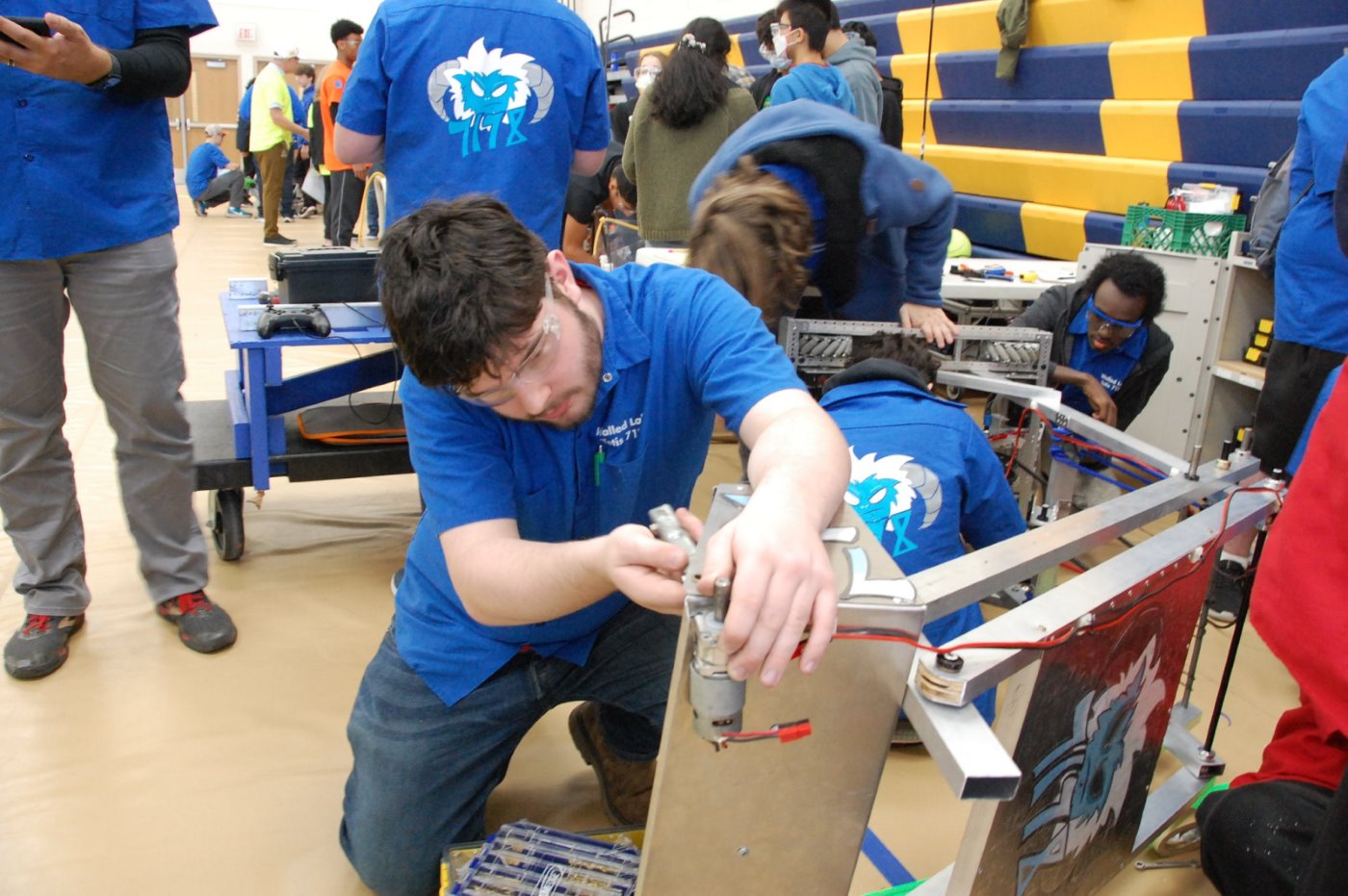 Students working on OCCRA robot in the pits.