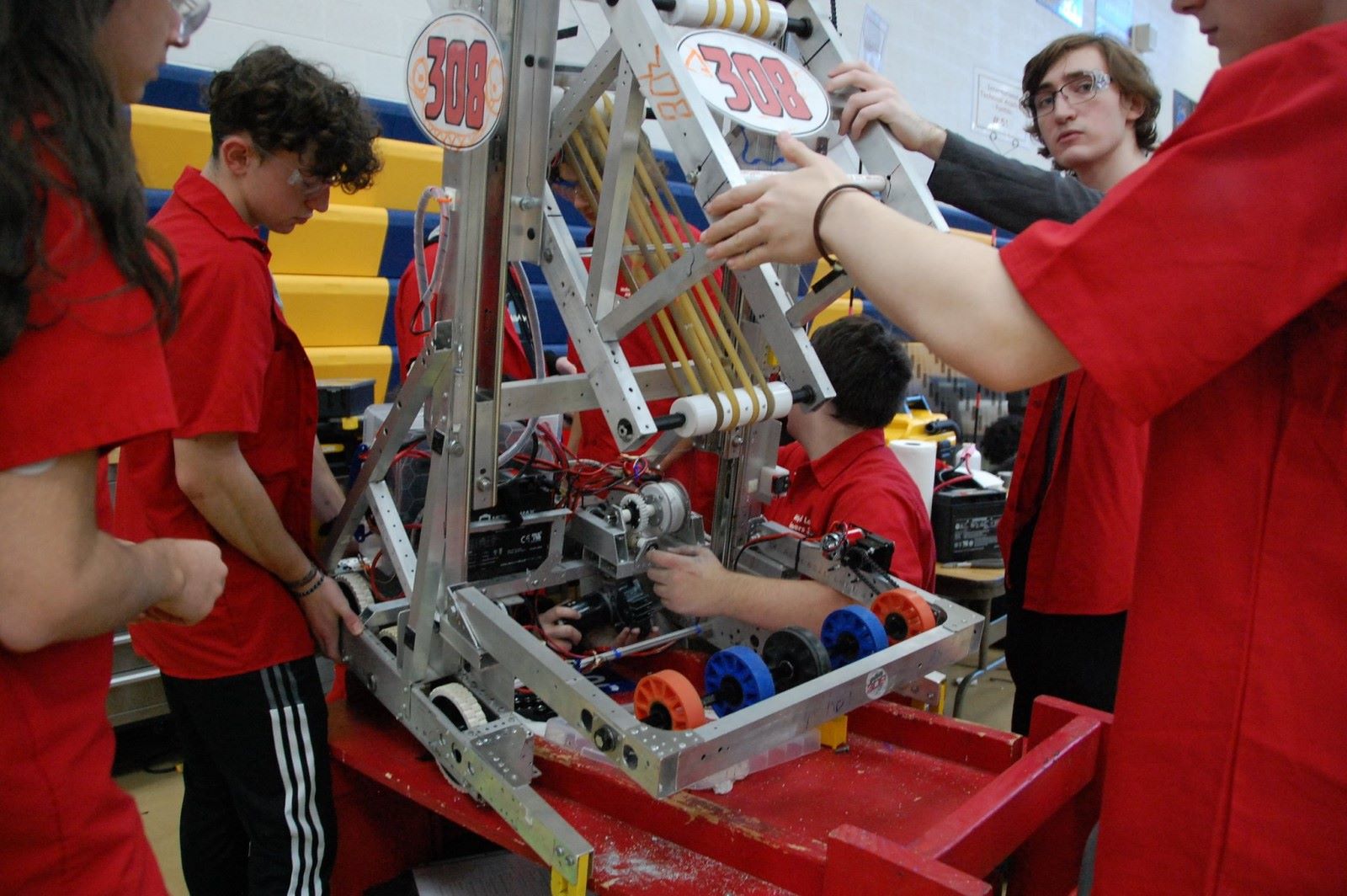 Students working on the 2022 OCCRA robot in the pits.