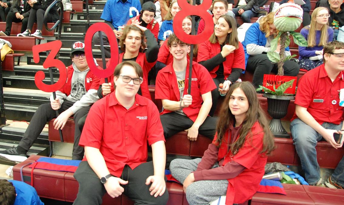 Students holding a 308 sign in the stands.