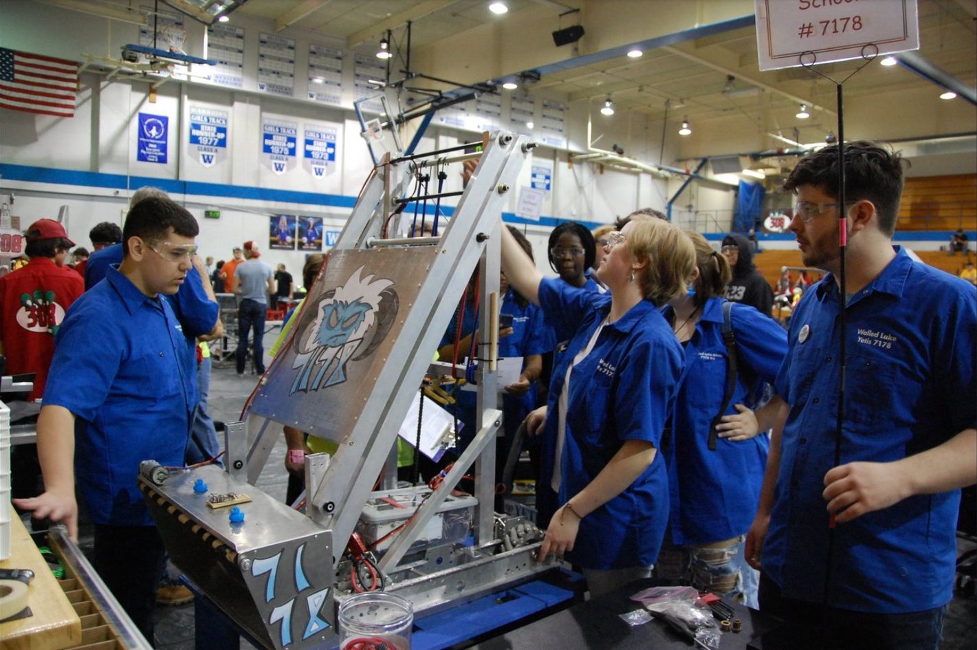 Students working on OCCRA robot in the pits.