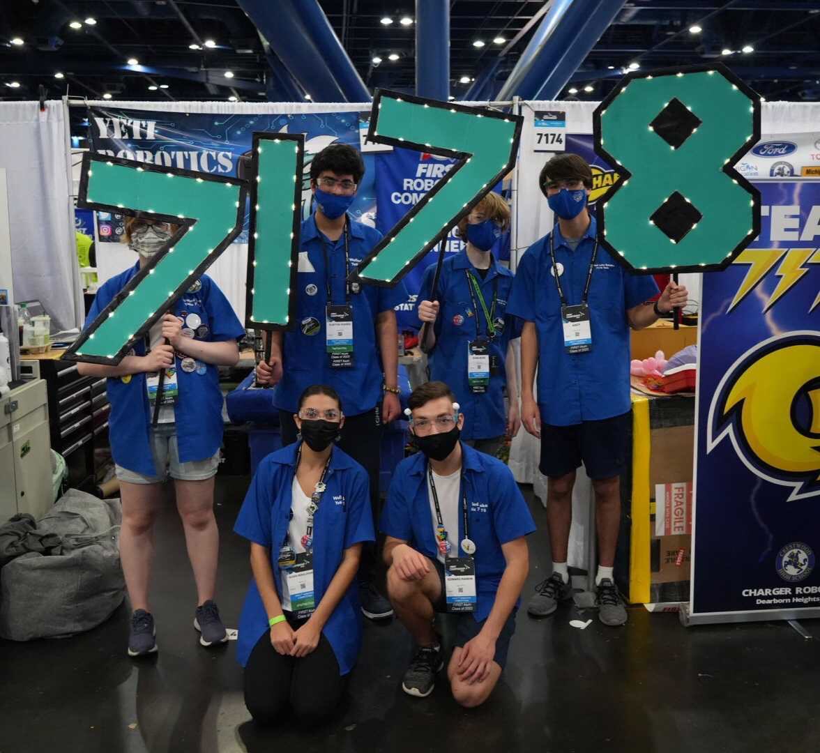 Students hold a 7178 sign at the pits in Worlds.